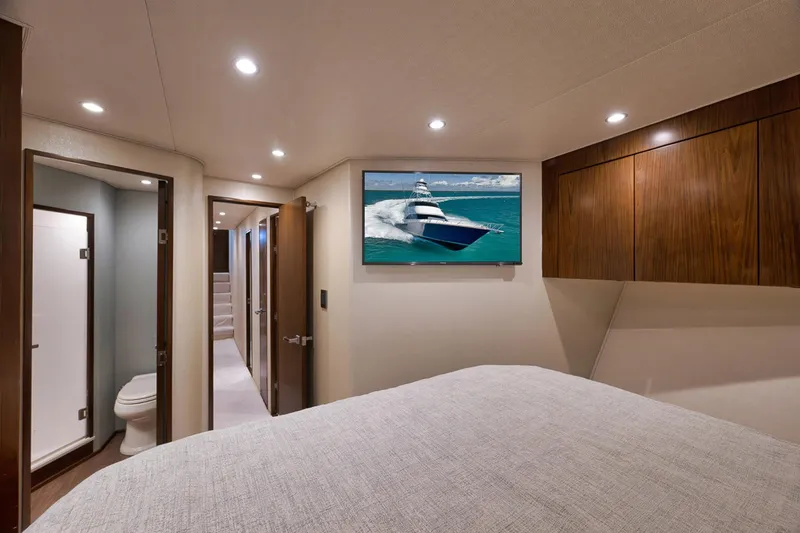Slide: The Image of Luxurious interior of 2015 Viking 76 Enclosed Bridge yacht bedroom with modern amenities. - 43