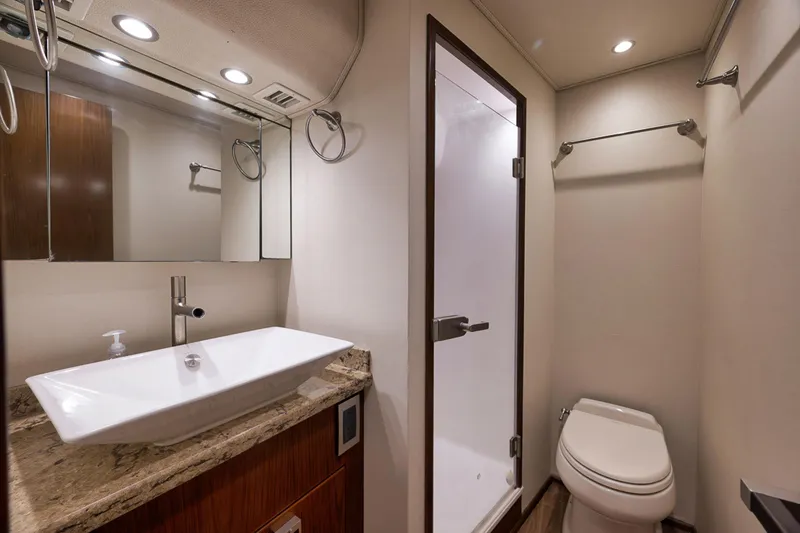 Slide: The Image of Luxurious bathroom in 2015 Viking 76 Enclosed Bridge yacht with modern fixtures. - 44