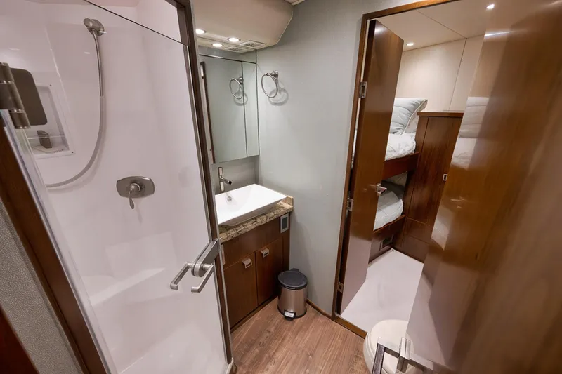 Slide: The Image of Bathroom and bunk beds in 2015 Viking 76 Enclosed Bridge yacht interior. - 47