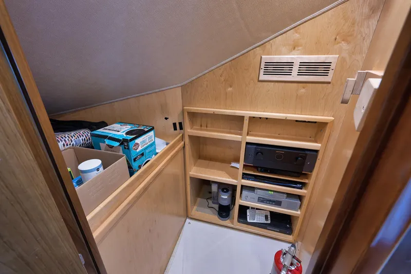 Slide: The Image of Storage area inside 2015 Viking 76 Enclosed Bridge yacht with shelves and equipment. - 48