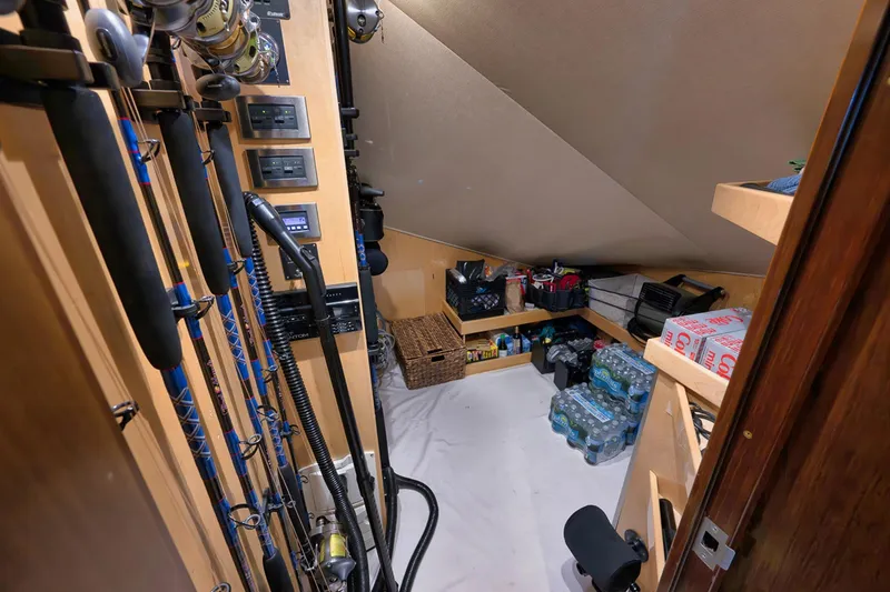 Slide: The Image of Storage room in a 2015 Viking 76 Enclosed Bridge yacht with fishing rods and supplies. - 49