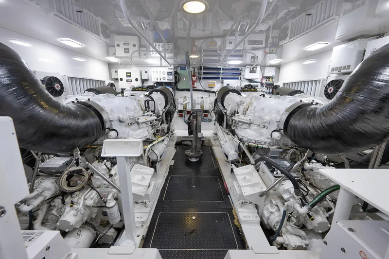 Slide: The Image of Engine room of a 2015 Viking 76 Enclosed Bridge yacht, showcasing dual engines. - 50