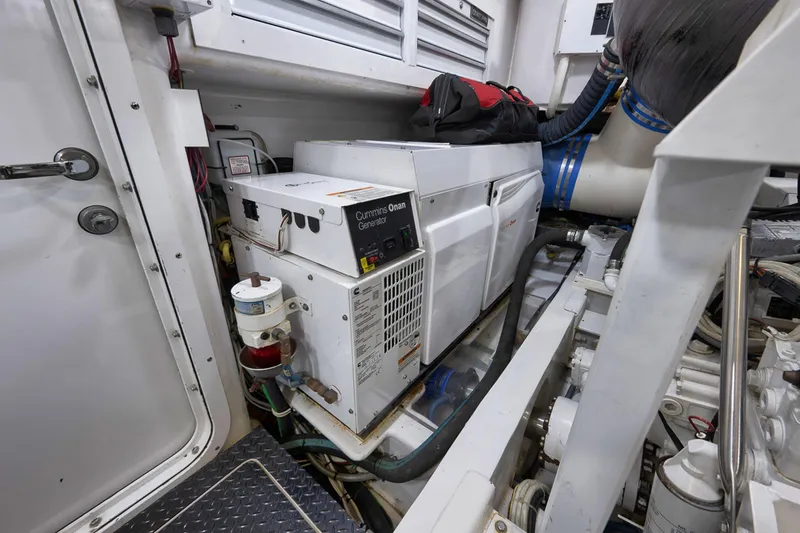 Slide: The Image of Engine room of 2015 Viking 76 Enclosed Bridge with Cummins Onan generator. - 52