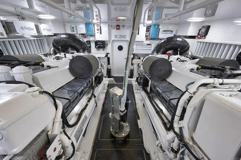 Slide: The Image of Engine room of 2015 Viking 76 Enclosed Bridge yacht, showcasing dual engines and equipment. - 53