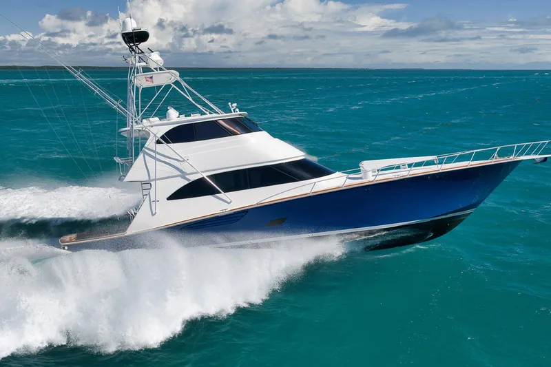 Slide: The Image of 2015 Viking 76 Enclosed Bridge yacht cruising on turquoise ocean waters. - 7