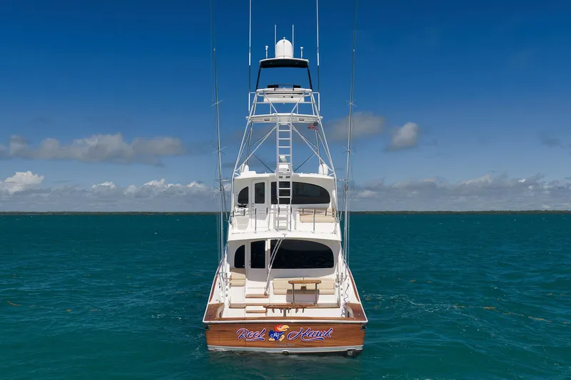 Slide: The Image of 2015 Viking 76 Enclosed Bridge yacht on open sea under clear blue sky. - 8