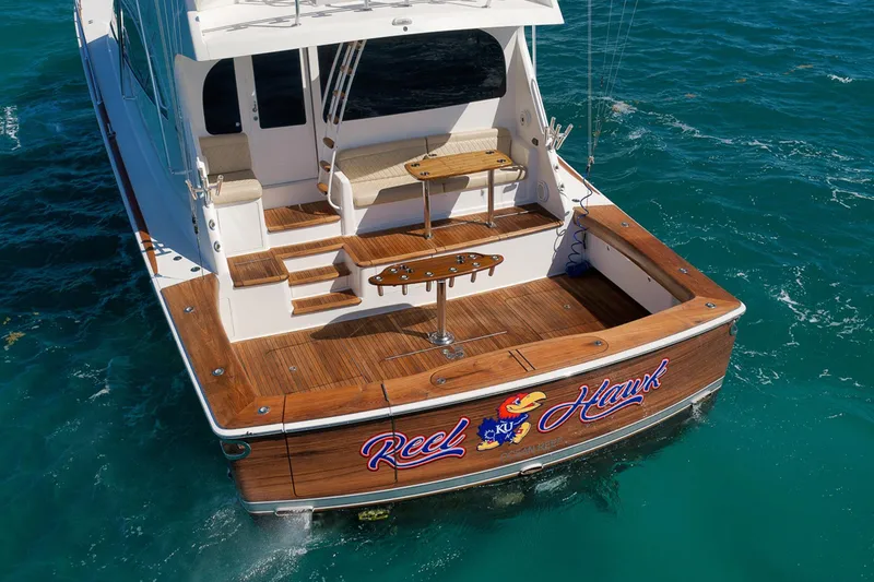 Slide: The Image of 2015 Viking 76 Enclosed Bridge yacht on blue ocean water. - 9