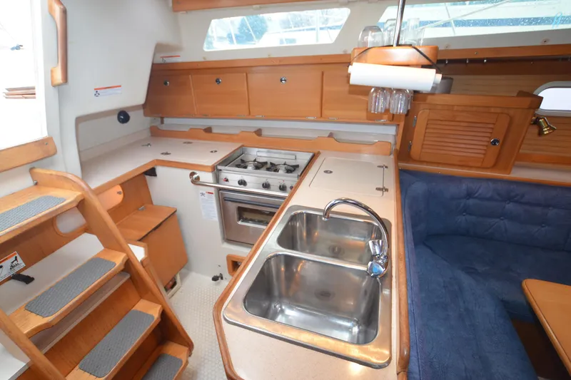 Slide: The Image of Interior of 2003 Catalina 36 MkII sailboat with kitchen and seating area. - 10