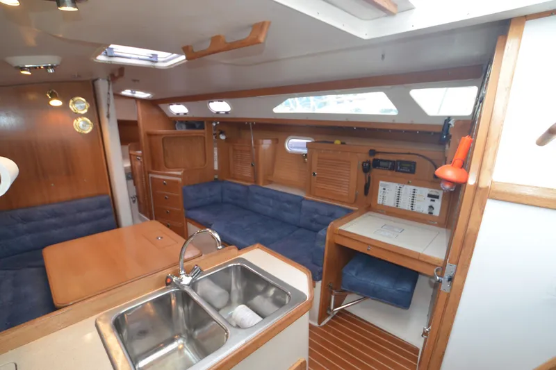 Slide: The Image of Interior of 2003 Catalina 36 MkII sailboat with wood finish and blue seating. - 12
