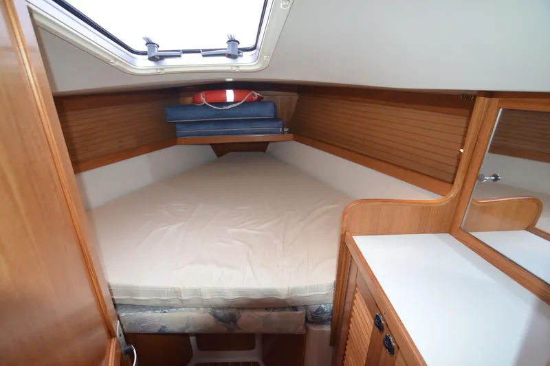Slide: The Image of Cozy cabin interior of 2003 Catalina 36 MkII sailboat with wooden finish and bedding. - 18