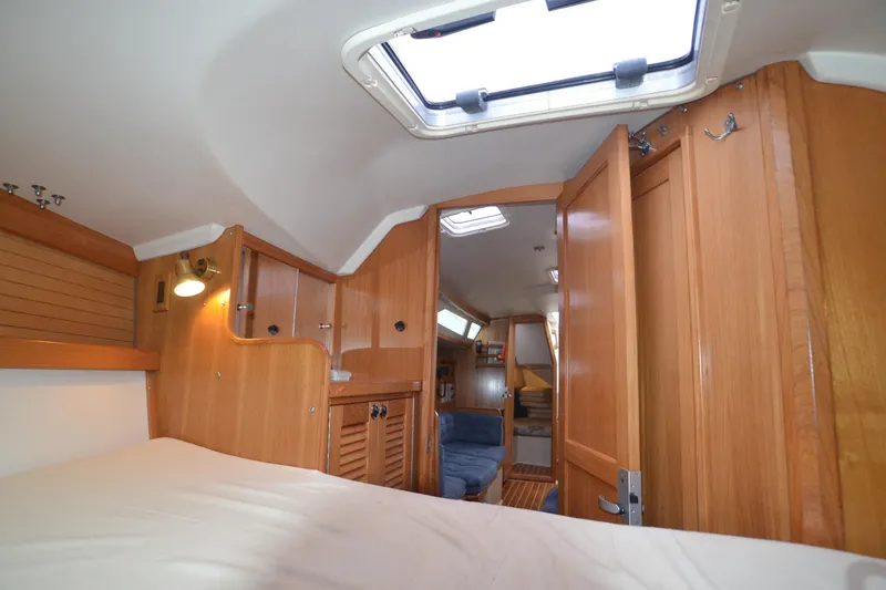 Slide: The Image of Interior of 2003 Catalina 36 MkII sailboat with wooden cabinetry and cozy seating area. - 19