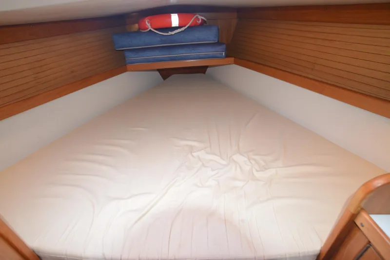 Slide: The Image of Cozy V-berth cabin in 2003 Catalina 36 MkII sailboat with wooden paneling and cushions. - 22