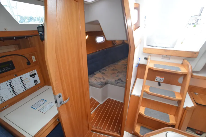 Slide: The Image of Interior of 2003 Catalina 36 MkII sailboat with wooden cabinetry and cozy sleeping area. - 23