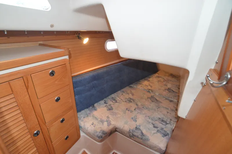 Slide: The Image of Interior cabin of 2003 Catalina 36 MkII sailboat with wooden cabinetry and cozy sleeping area. - 24