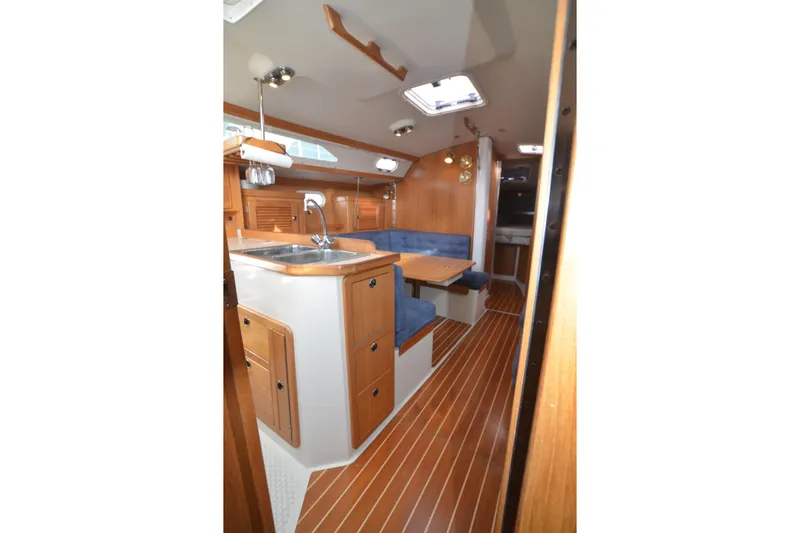 Slide: The Image of Interior of 2003 Catalina 36 MkII sailboat with wood finish and blue seating. - 26