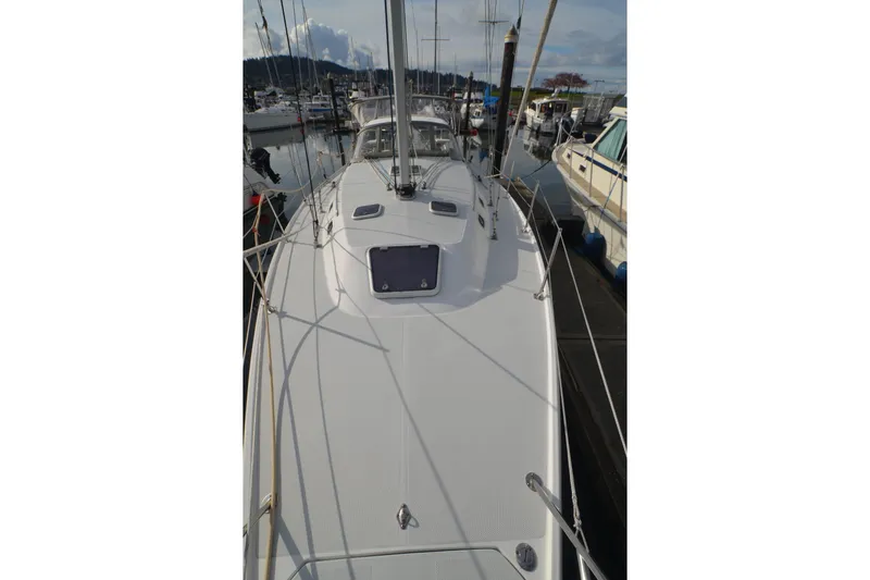 Slide: The Image of 2003 Catalina 36 MkII sailboat docked at a marina, showcasing its sleek deck design. - 7