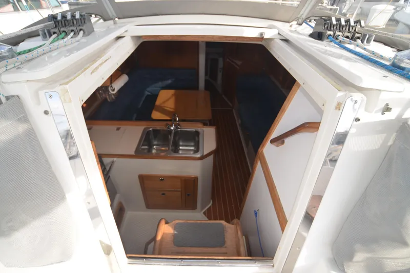 Slide: The Image of Interior view of 2003 Catalina 36 MkII sailboat, featuring kitchen and seating area. - 8