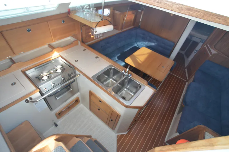 Slide: The Image of Interior of 2003 Catalina 36 MkII sailboat with kitchen and seating area. - 9
