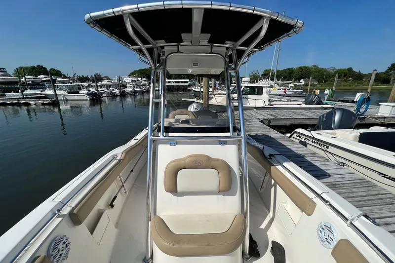 Slide: The Image of 2017 Key West 239 FS boat docked at marina, featuring spacious seating and sleek design. - 3