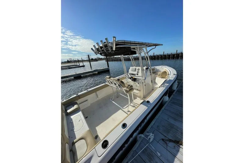 Slide: The Image of 2017 Key West 239 FS boat docked at marina, featuring spacious seating and sleek design. - 5