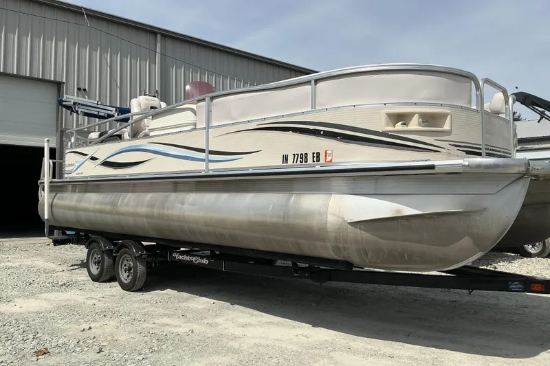 The Image of 2008 Misty Harbor 2285GM Grand Mistique pontoon boat on trailer outside warehouse. - 1