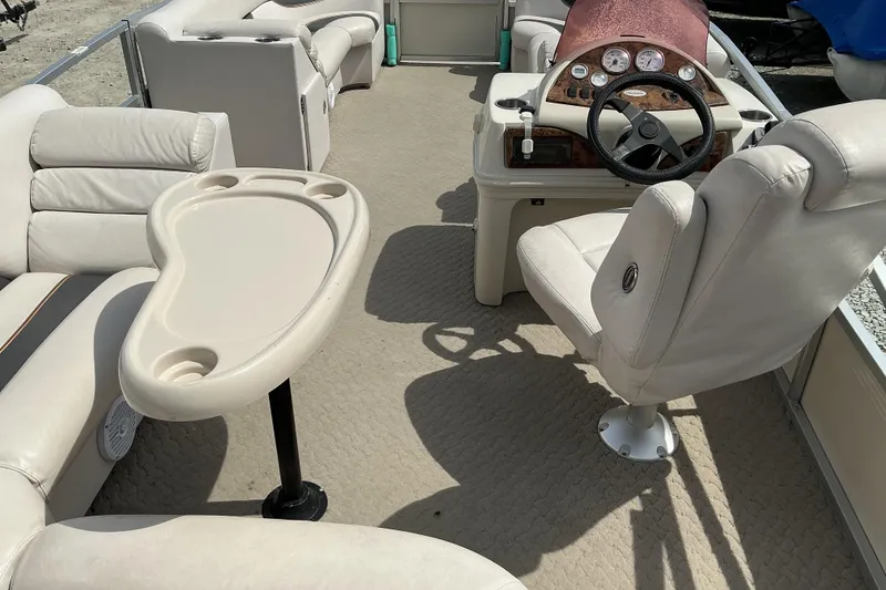 Slide: The Image of 2008 Misty Harbor 2285GM Grand Mistique boat interior with beige seating and steering console. - 11