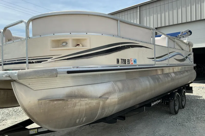 Slide: The Image of 2008 Misty Harbor 2285GM Grand Mistique pontoon boat on trailer outside a warehouse. - 3