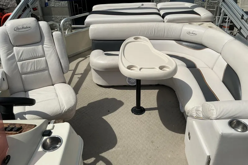Slide: The Image of 2008 Misty Harbor 2285GM Grand Mistique pontoon boat interior with plush seating and table. - 8