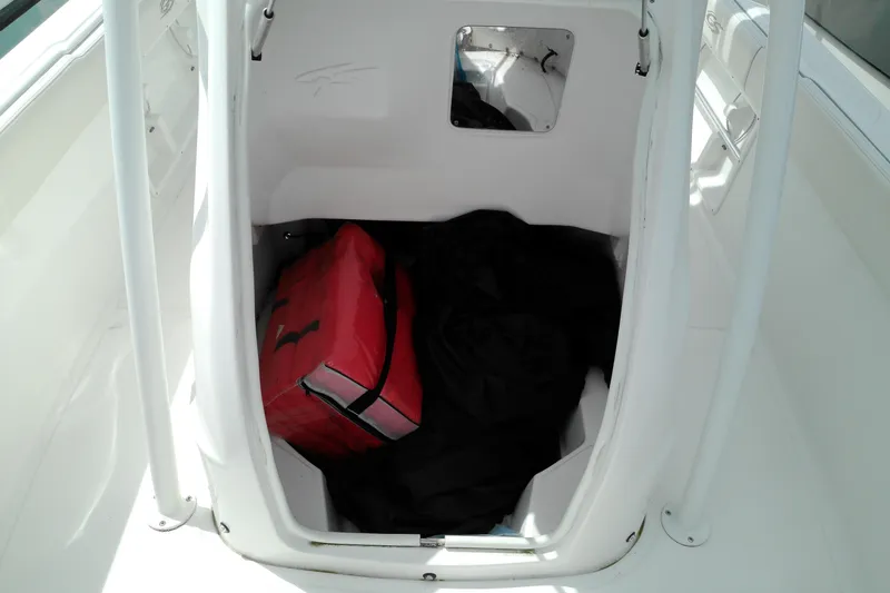 Slide: The Image of Storage compartment of 2023 Glasstream 240 CC boat with red bag inside. - 14