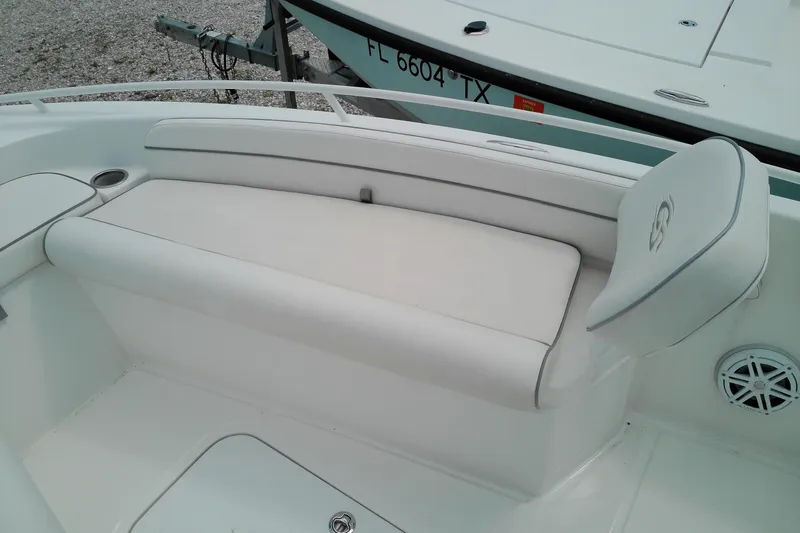 Slide: The Image of 2023 Glasstream 240 CC boat interior with white seating and speaker detail. - 16