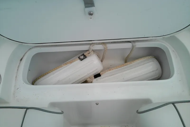 Slide: The Image of Storage compartment with fenders on a 2023 Glasstream 240 CC boat. - 19
