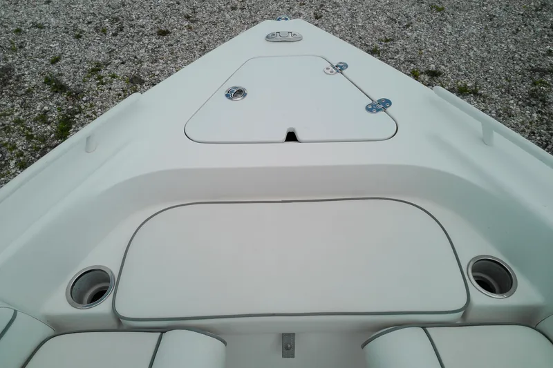 Slide: The Image of 2023 Glasstream 240 CC boat deck with storage compartments and cup holders. - 20