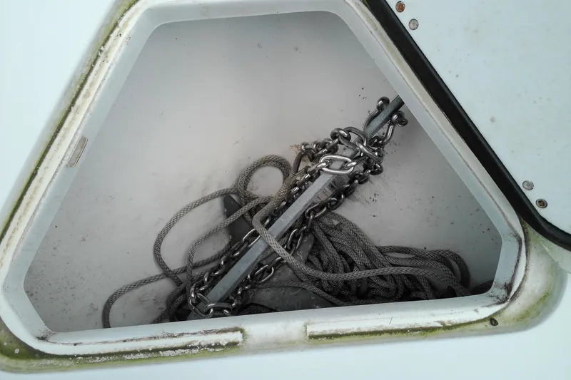 Slide: The Image of Anchor storage compartment on 2023 Glasstream 240 CC boat with chain and rope. - 21