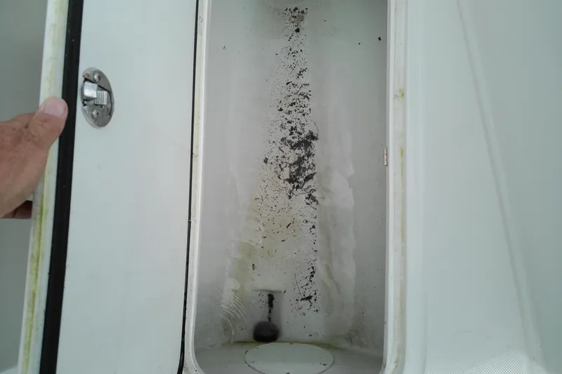 Slide: The Image of Open storage compartment on 2023 Glasstream 240 CC boat, showing interior condition. - 22