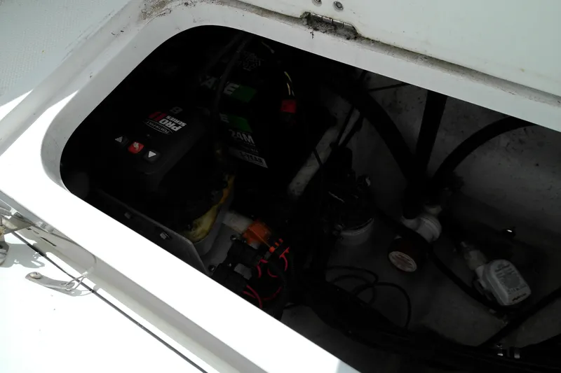 Slide: The Image of Battery compartment of 2023 Glasstream 240 CC boat, showing wiring and components. - 6