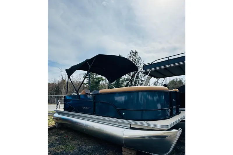 The Image of 2026 Crest Conquest SE 200 Cruise pontoon boat with canopy, parked outdoors. - 0