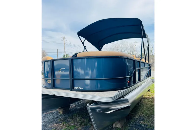 Slide: The Image of 2026 Crest Conquest SE 200 Cruise pontoon boat with blue exterior and canopy. - 5