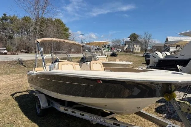 The Image of 2022 Scout 195 Sport Dorado boat on trailer, parked outdoors under clear sky. - 0