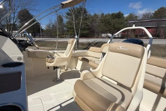Slide: The Image of 2022 Scout 195 Sport Dorado boat interior with beige seating and steering console. - 3