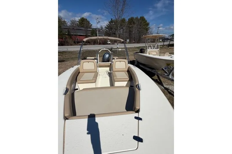 Slide: The Image of 2022 Scout 195 Sport Dorado boat with beige seating, parked outdoors. - 5
