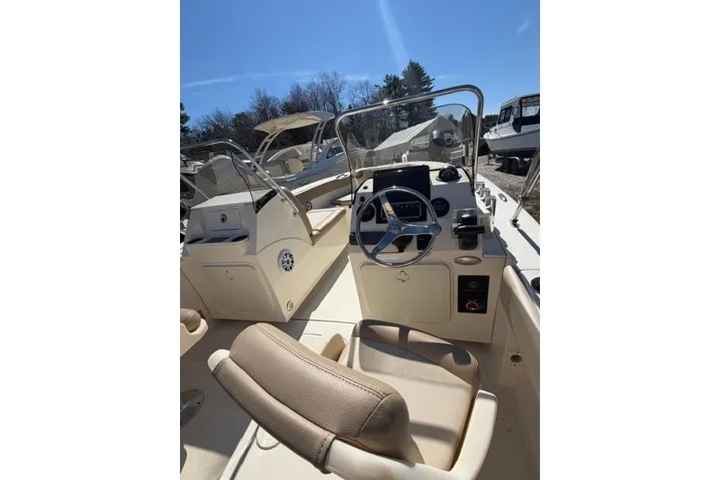 Slide: The Image of 2022 Scout 195 Sport Dorado boat interior with steering wheel and seating. - 6
