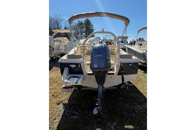 Slide: The Image of 2022 Scout 195 Sport Dorado boat with outboard motor, parked outdoors. - 7