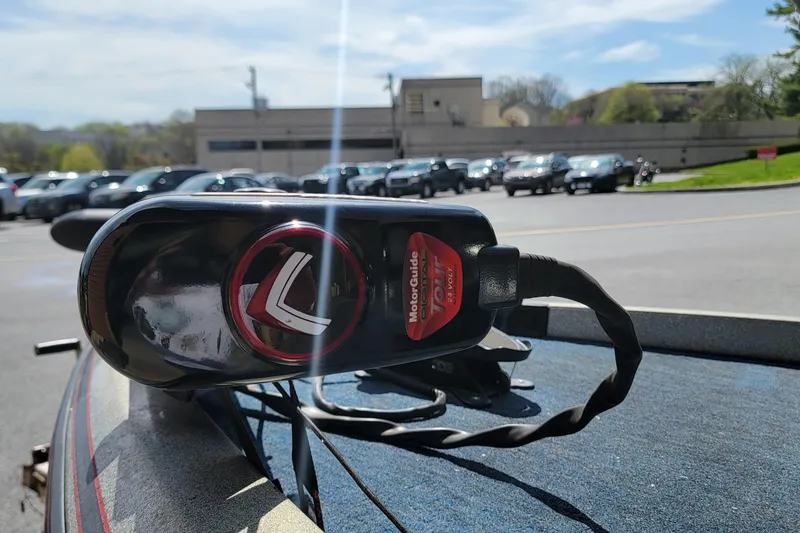 Slide: The Image of MotorGuide Tour trolling motor on a 1995 Ranger boat, parked outdoors. - 10