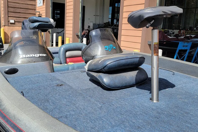 Slide: The Image of 1995 Ranger boat interior with blue seats and fishing rod holder. - 12