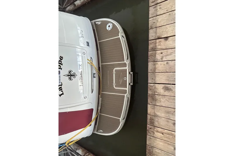 Slide: The Image of 2010 Chaparral Signature 370 docked, showing rear deck and wooden pier. - 10