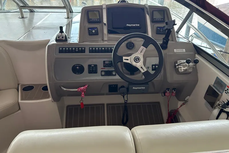Slide: The Image of Cockpit of 2010 Chaparral Signature 370 with steering wheel and Raymarine navigation system. - 14