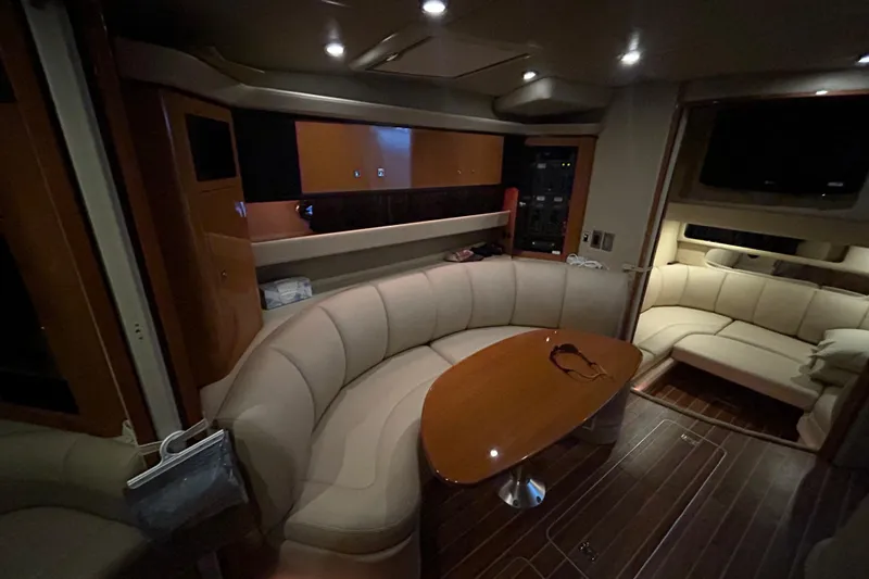 Slide: The Image of Luxurious interior of 2010 Chaparral Signature 370 yacht with plush seating and wooden table. - 19