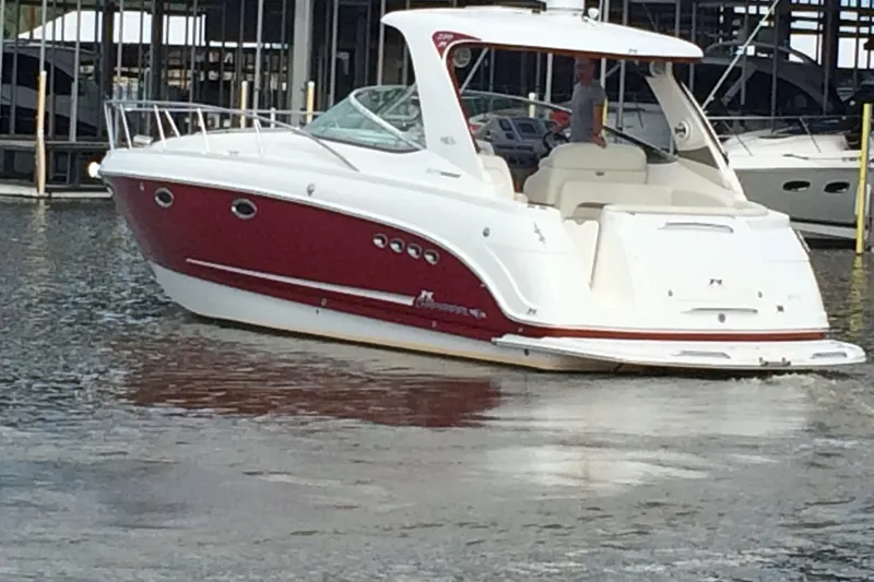 Slide: The Image of Chaparral Signature 370 boat, 2010 model, docked in marina, red and white design. - 2