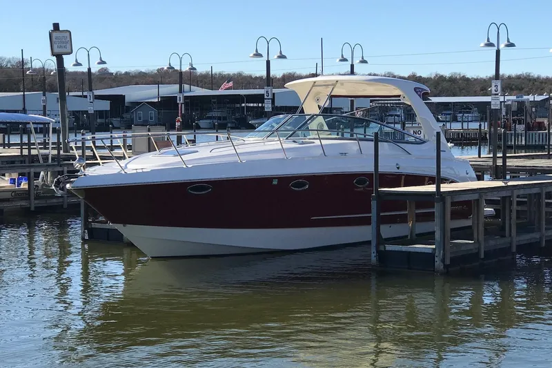 Slide: The Image of 2010 Chaparral Signature 370 boat docked at a marina under clear skies. - 3