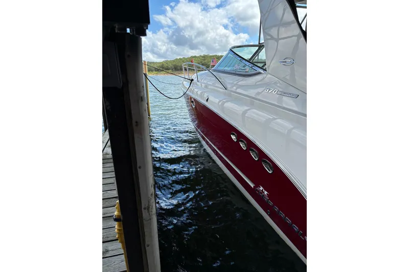 Slide: The Image of 2010 Chaparral Signature 370 yacht docked by the water under a cloudy sky. - 34
